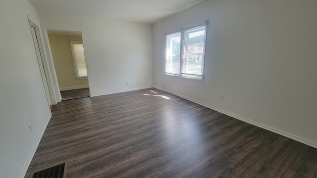 spare room featuring dark hardwood / wood-style flooring