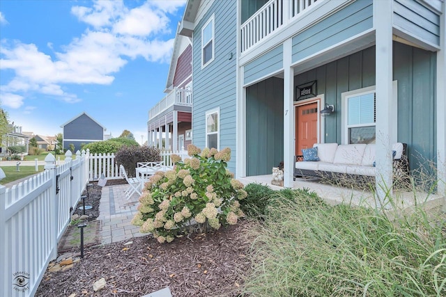 view of side of home featuring a balcony