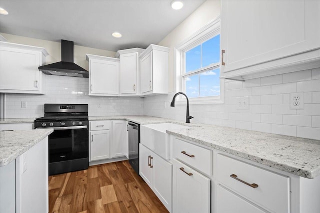 kitchen featuring dishwasher, range, white cabinets, dark hardwood / wood-style flooring, and wall chimney exhaust hood