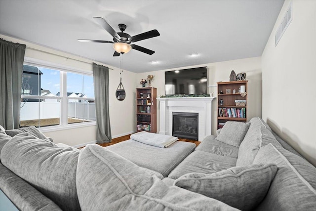 living room featuring wood-type flooring and ceiling fan