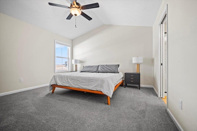 bedroom featuring dark colored carpet, lofted ceiling, and ceiling fan