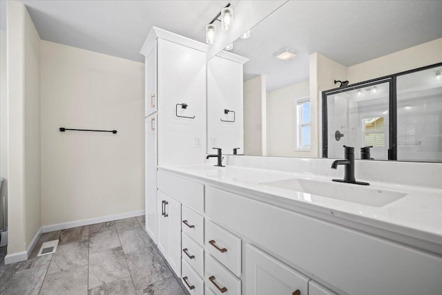 bathroom featuring vanity and a shower with shower door