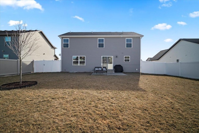 back of house with a lawn and a patio