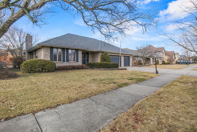 ranch-style home featuring an attached garage, brick siding, driveway, a chimney, and a front yard