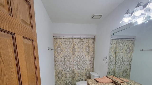 bathroom with vanity, toilet, and walk in shower