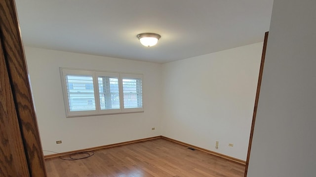 empty room with light hardwood / wood-style floors