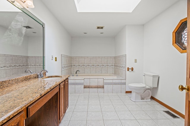 bathroom with a garden tub, tile patterned flooring, a skylight, vanity, and visible vents