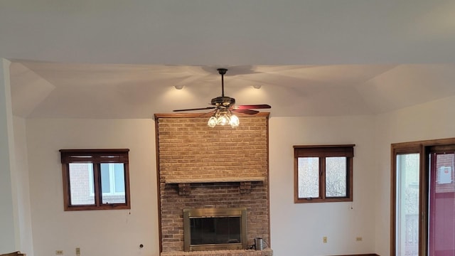 unfurnished living room featuring a fireplace and ceiling fan