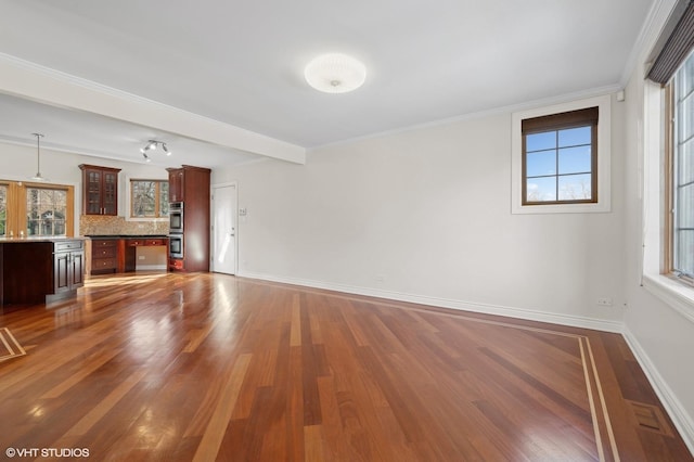 unfurnished living room with crown molding and dark hardwood / wood-style flooring