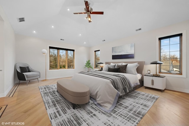 bedroom with vaulted ceiling and light hardwood / wood-style flooring