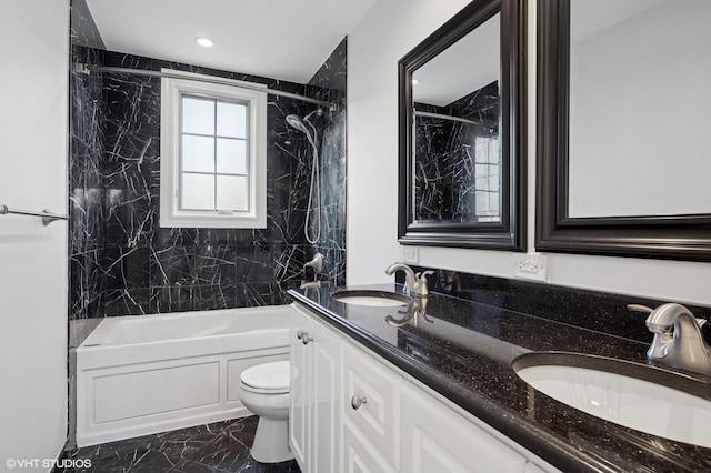 full bathroom featuring tiled shower / bath combo, vanity, and toilet