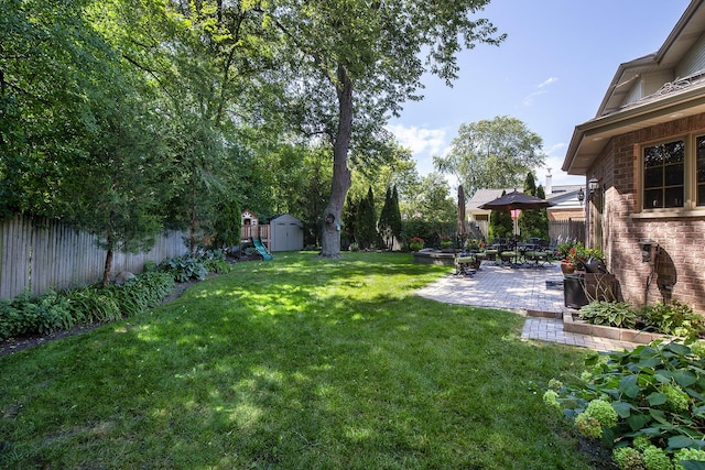 view of yard with a patio area and a shed