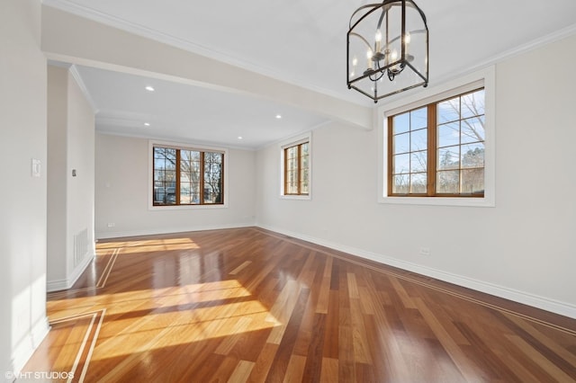 interior space with ornamental molding, hardwood / wood-style floors, and a chandelier