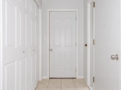 hallway featuring light tile patterned floors