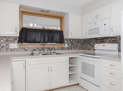 kitchen featuring white cabinetry, white appliances, sink, and backsplash