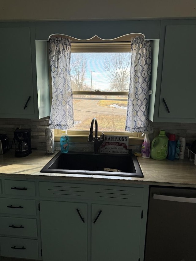 202 Hickory Dr, Roberts, IL 60962 - kitchen featuring sink, backsplash, green cabinetry, and black dishwasher