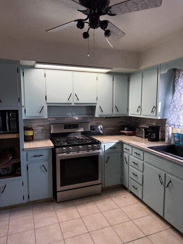 202 Hickory Dr, Roberts, IL 60962 - kitchen featuring stainless steel gas stove, light tile patterned floors, decorative backsplash, and ceiling fan