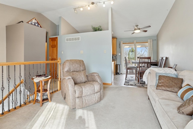 living room with ceiling fan, lofted ceiling, and light carpet