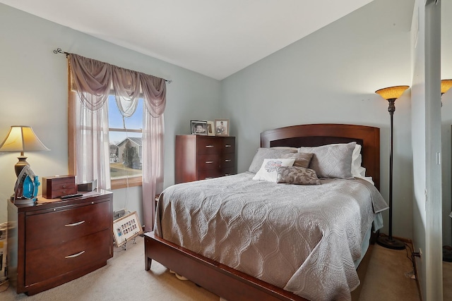 carpeted bedroom with vaulted ceiling