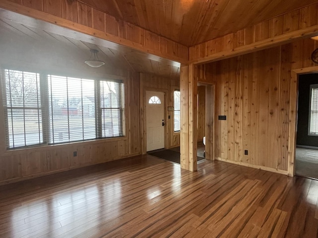 entryway with wooden walls, wood ceiling, and dark hardwood / wood-style flooring