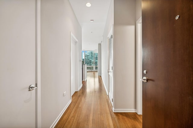 corridor with light hardwood / wood-style flooring