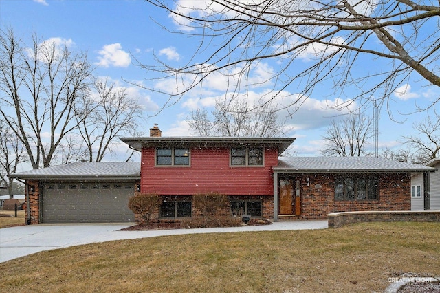 tri-level home featuring a garage and a front yard