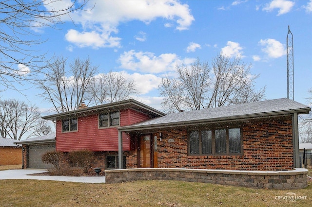 split level home featuring a garage and a front lawn