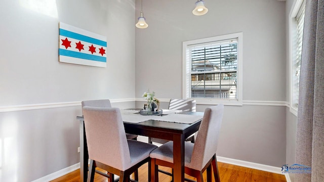 dining area featuring wood finished floors and baseboards