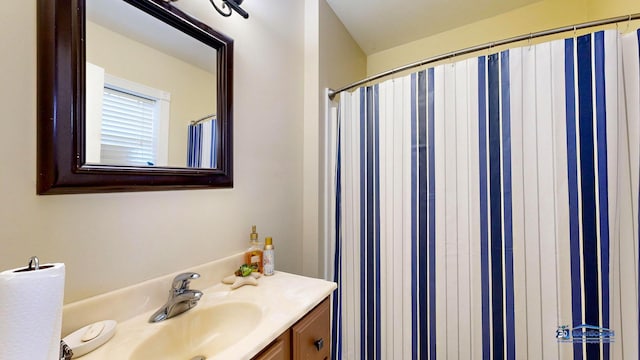 full bath with a shower with curtain and vanity