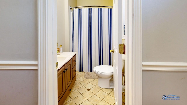 full bath with tile patterned floors, curtained shower, toilet, and vanity