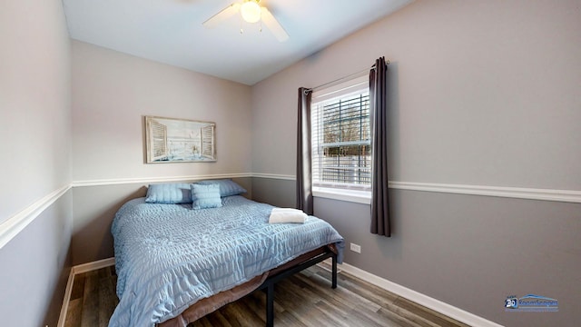 bedroom with ceiling fan, baseboards, and wood finished floors