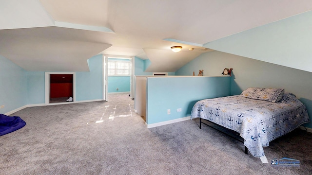 bedroom with vaulted ceiling, baseboards, and carpet floors