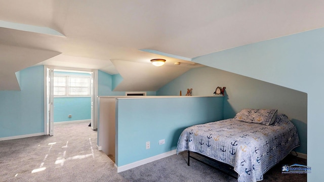 bedroom with carpet flooring, baseboards, and lofted ceiling