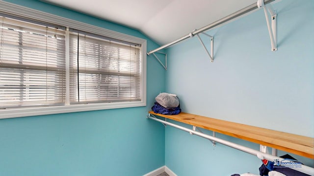 walk in closet with lofted ceiling