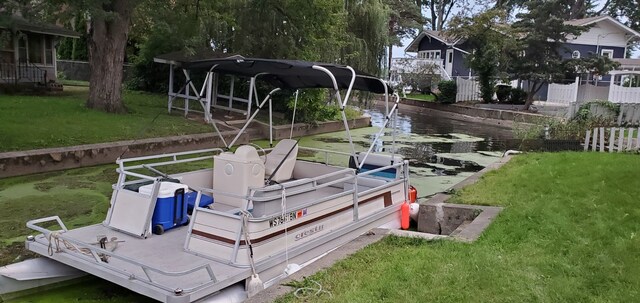 dock area featuring a lawn and fence