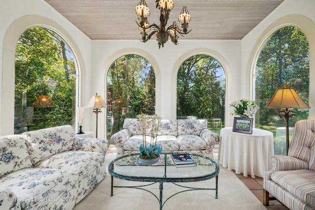 sunroom / solarium featuring an inviting chandelier