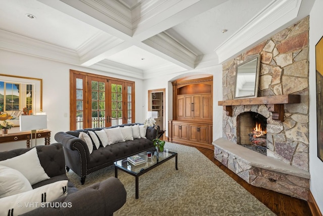 living room with crown molding, a fireplace, wood-type flooring, french doors, and beamed ceiling