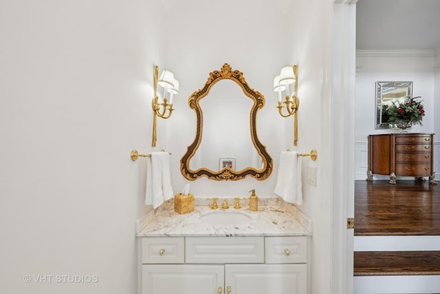 bathroom with crown molding and vanity