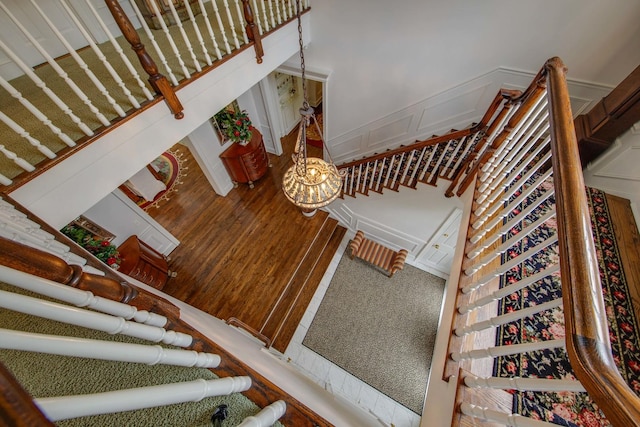 stairway featuring carpet flooring