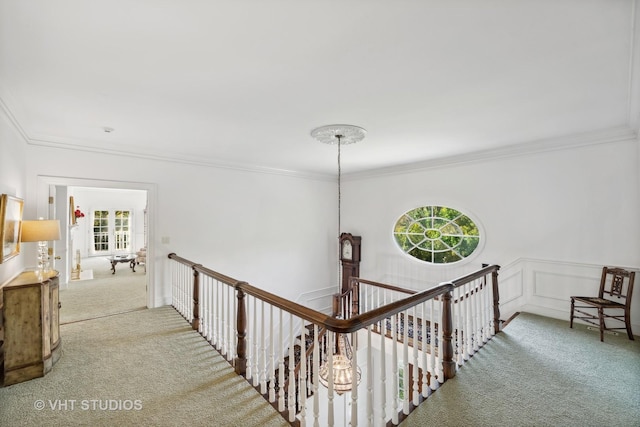 hall with crown molding and carpet