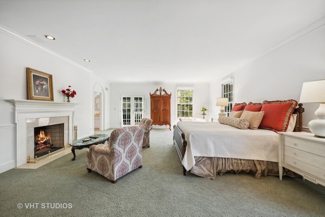 carpeted bedroom with crown molding and a premium fireplace