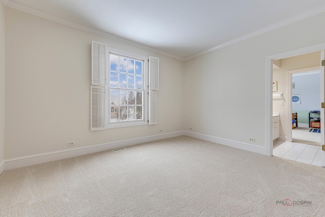 carpeted spare room featuring ornamental molding