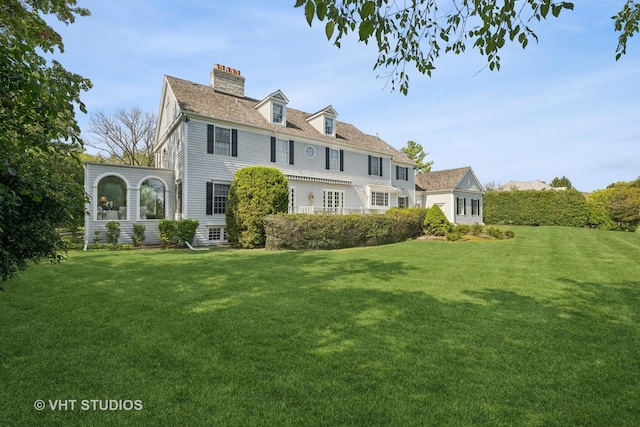 back of house featuring a yard