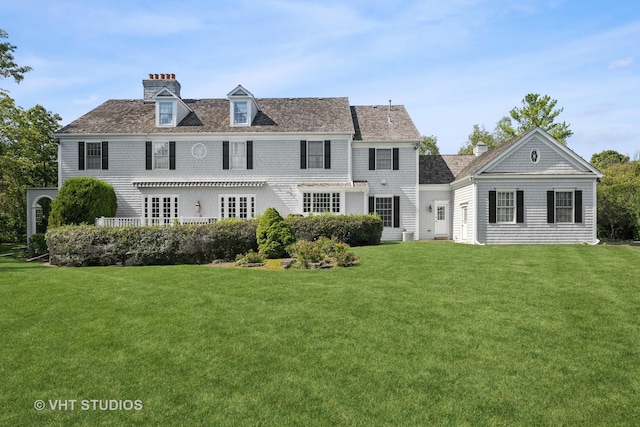 rear view of property with a yard