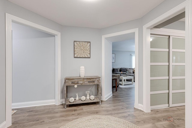 corridor with hardwood / wood-style flooring