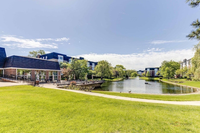 view of community with a water view and a yard