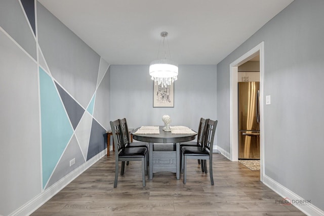 dining room featuring a notable chandelier and wood-type flooring