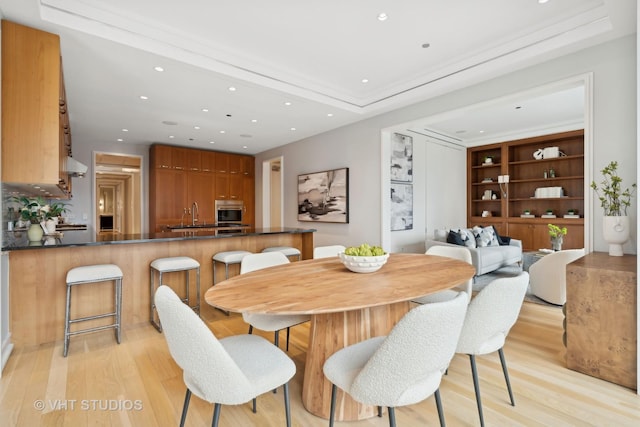 dining room featuring sink and light wood-type flooring