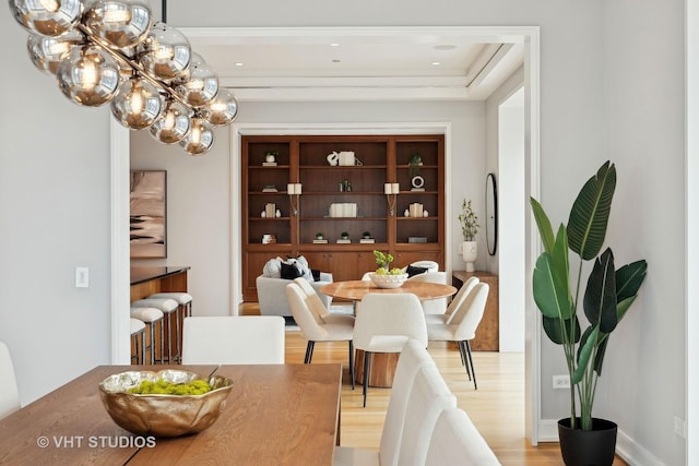 dining space with a chandelier and light hardwood / wood-style floors