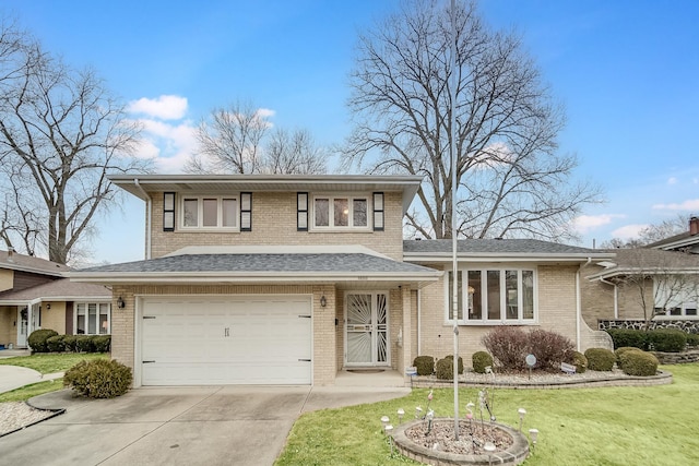 tri-level home featuring a garage and a front lawn